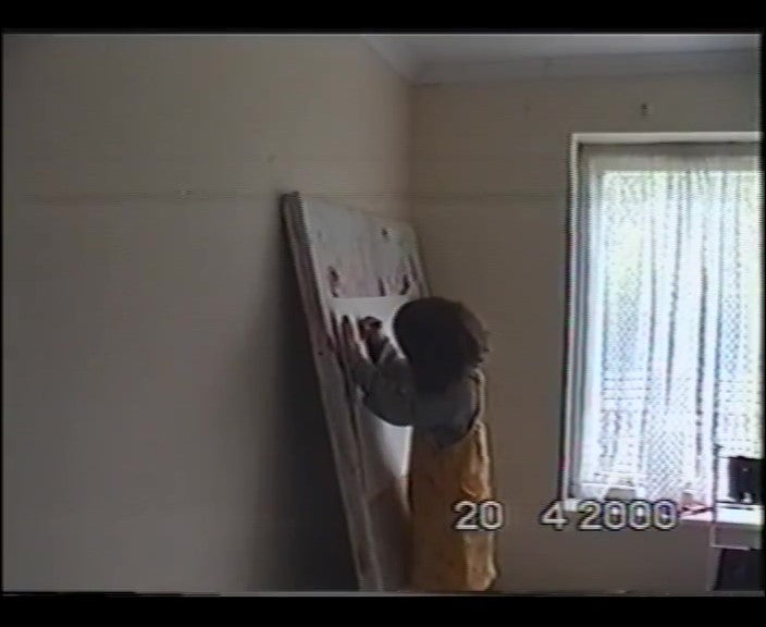 Load video: A 4 year old Nat, drawing a small portrait of my grandma using charcoal. She smiles and giggles to the camera.